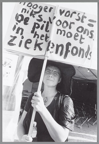Vrouw met spandoek: 'Hoogervorst = niks voor ons de pil moet in het ziekenfonds' tijdens de manifestatie 'Keer het Tij', tegen de bezuinigingsplannen van het kabinet Balkenende II. 2003