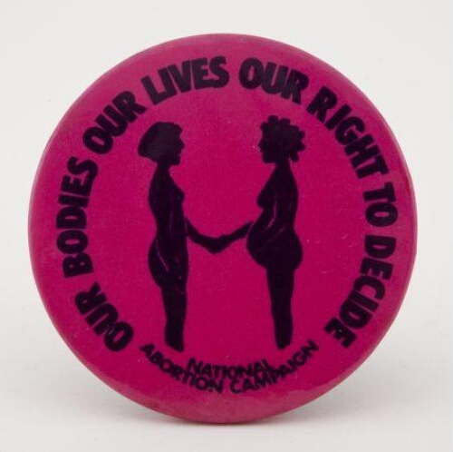 Button. 'Our bodies our lives our right to decide'