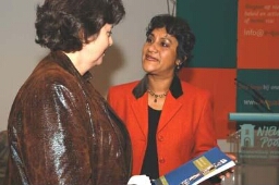 Rita Verdonk, minister van vreemdelingenzaken en integratie ( l.) ontvangt het boek 'Vrouwen in het migratiebeleid' van Joan Ferrier, directeur van E-Quality 2003