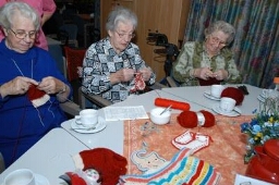 Oudere vrouwen doen aan handwerken in het verzorgingstehuis. 2004