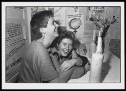 'Joke en Karmin hebben een onderonsje in de gang tijdens de heropening van het vrouwenhuis 1983