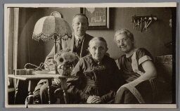 Familieportret in huiskamer, echtpaar met moeder. 193?